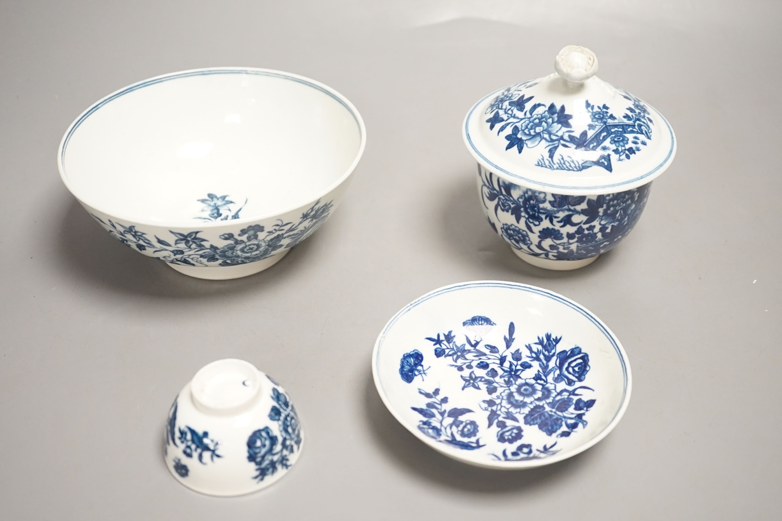 A Worcester sucrier and cover with floral finial printed in blue underglaze with the Fence pattern, Worcester toy size teabowl and saucer, and a Worcester bowl printed with the Three Flowers pattern c.1775-sucrier and co